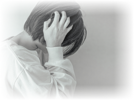 頭を両手で抱え、苦しそうにうずくまっている人